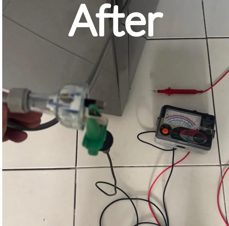 Replaced fridge plug being checked with a test and tag meter