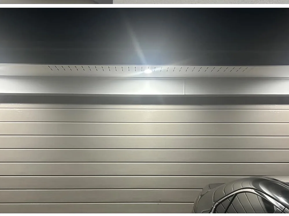 Row of new downlights lighting a garage door at night