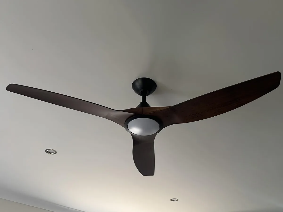 Dark timber three blade fan with LED light in a lounge