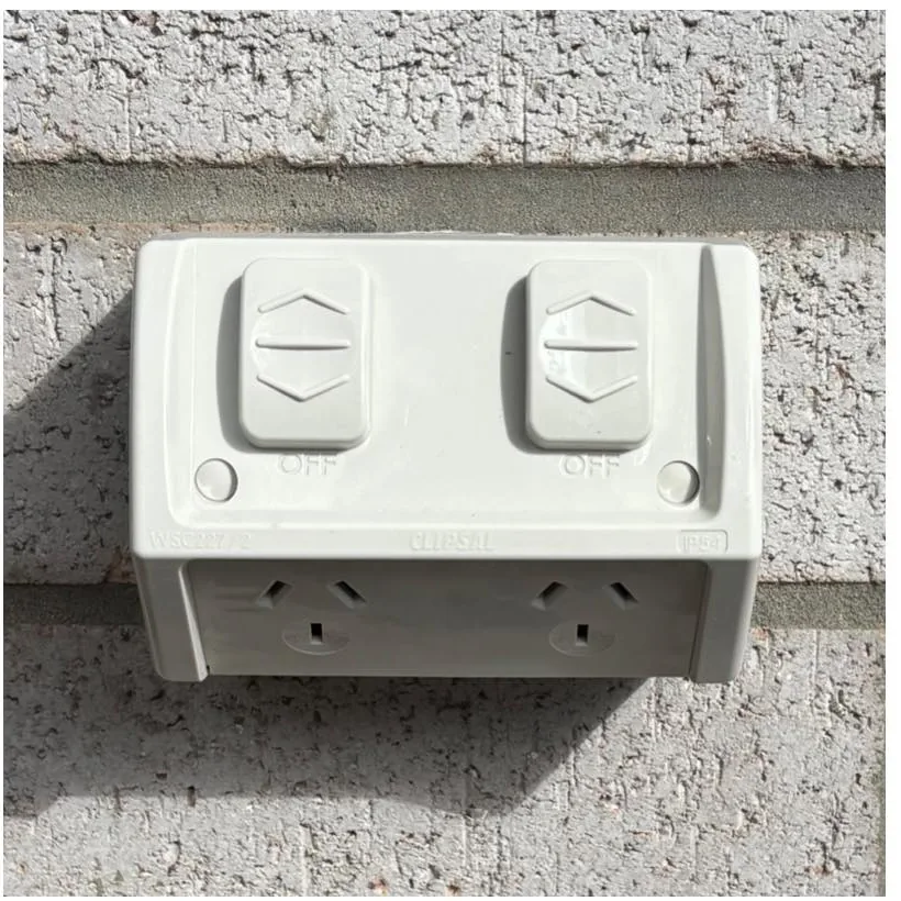 Weatherproof outdoor double power point on a rendered wall