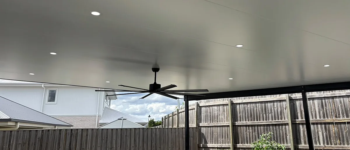 Fly-over patio with a large black ceiling fan and a grid of new downlights