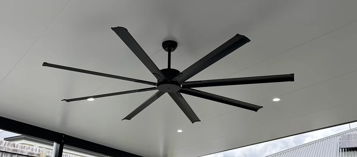 Eight blade black patio fan with downlights in the patio ceiling
