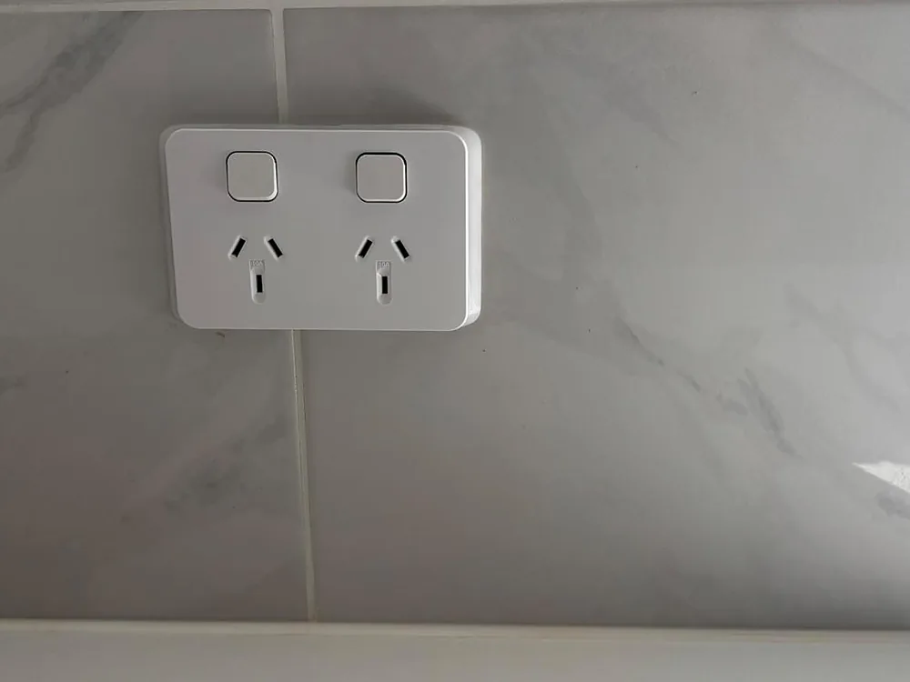 New white double power point set neatly into a marble look tiled splashback