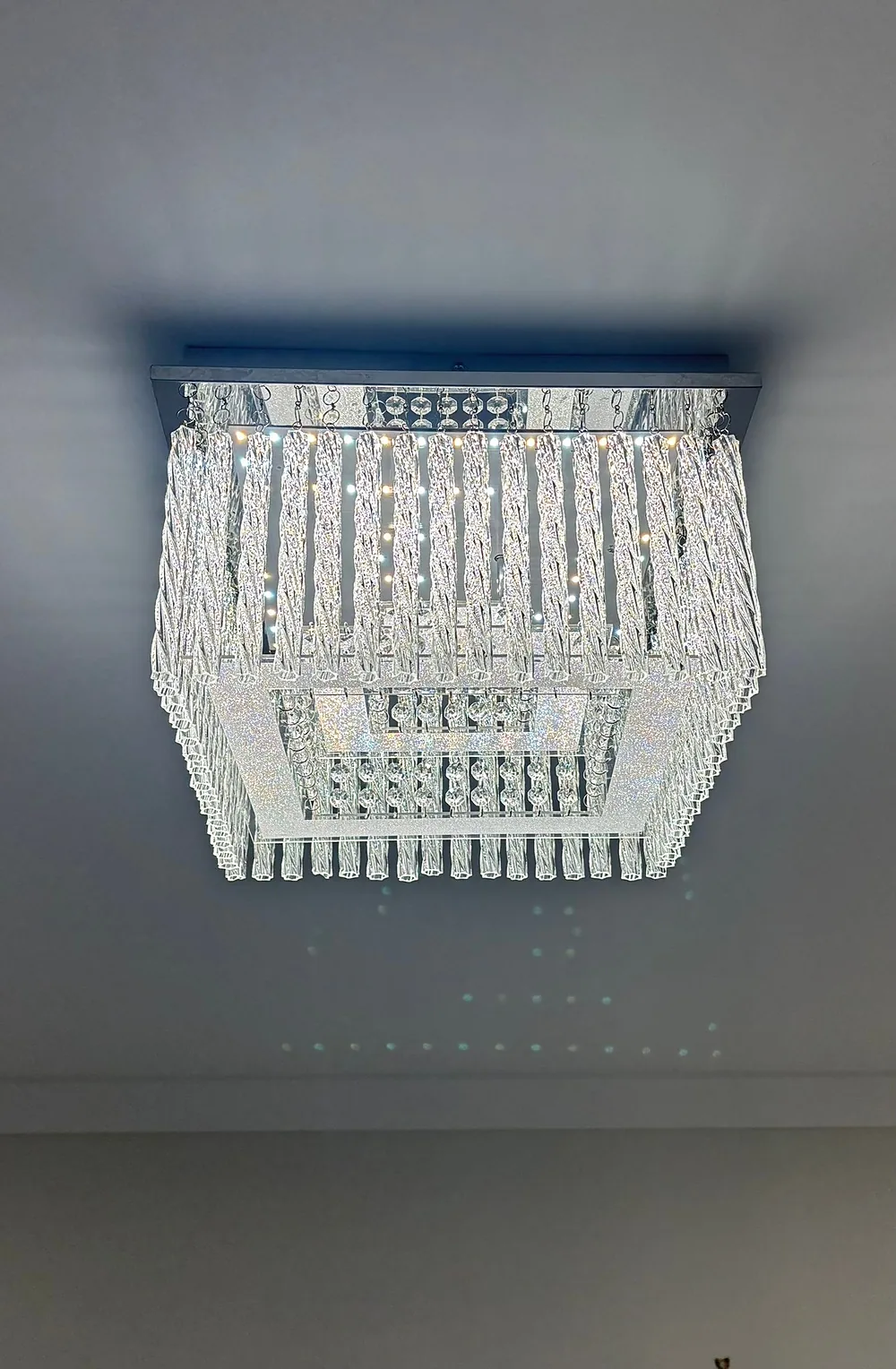 Square crystal ceiling light installed in a hallway